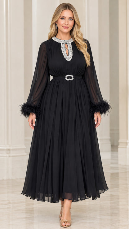 Front view of black pleated chiffon maxi dress with crystal neckline and feather cuffs
