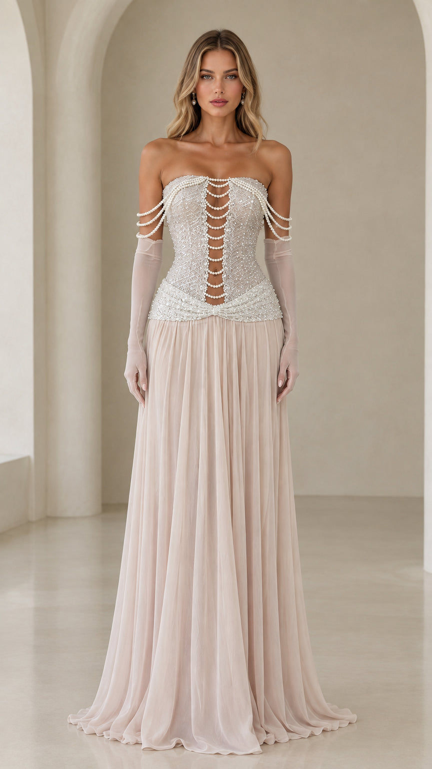 Front view of model wearing champagne strapless pearl corset evening gown with sheer gloves