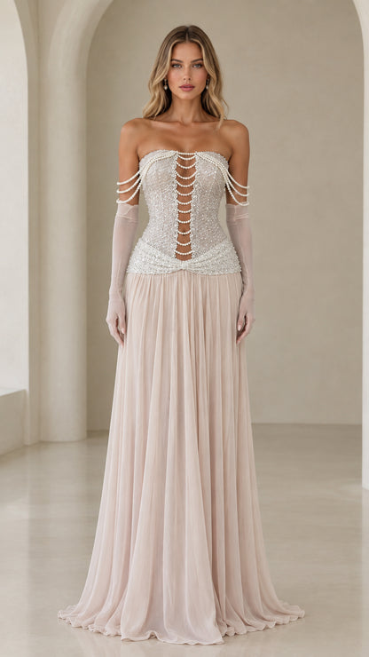 Front view of model wearing champagne strapless pearl corset evening gown with sheer gloves