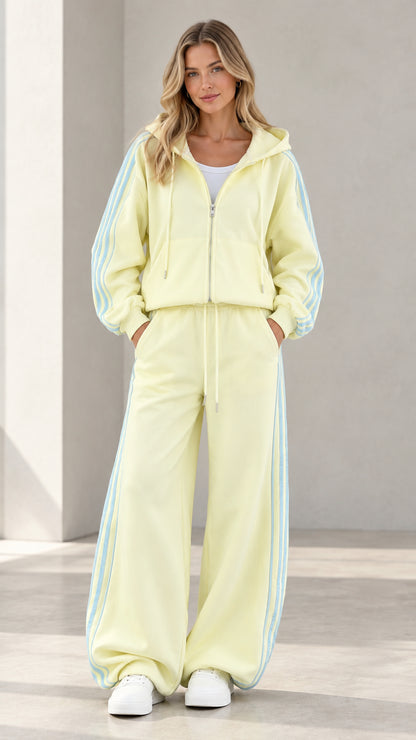 Full front view of model wearing butter yellow zip hoodie and wide-leg sweatpants set with side stripes