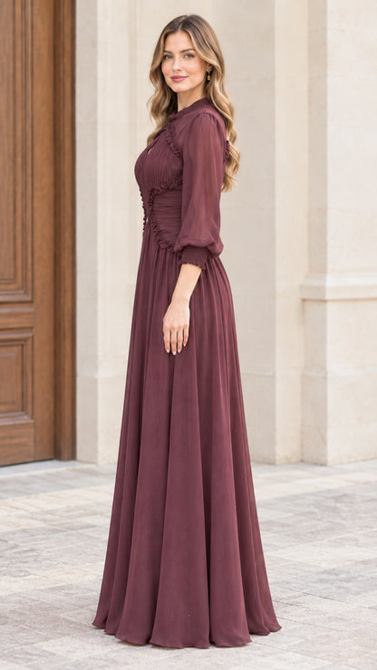 Side profile view of woman modeling long burgundy chiffon evening dress