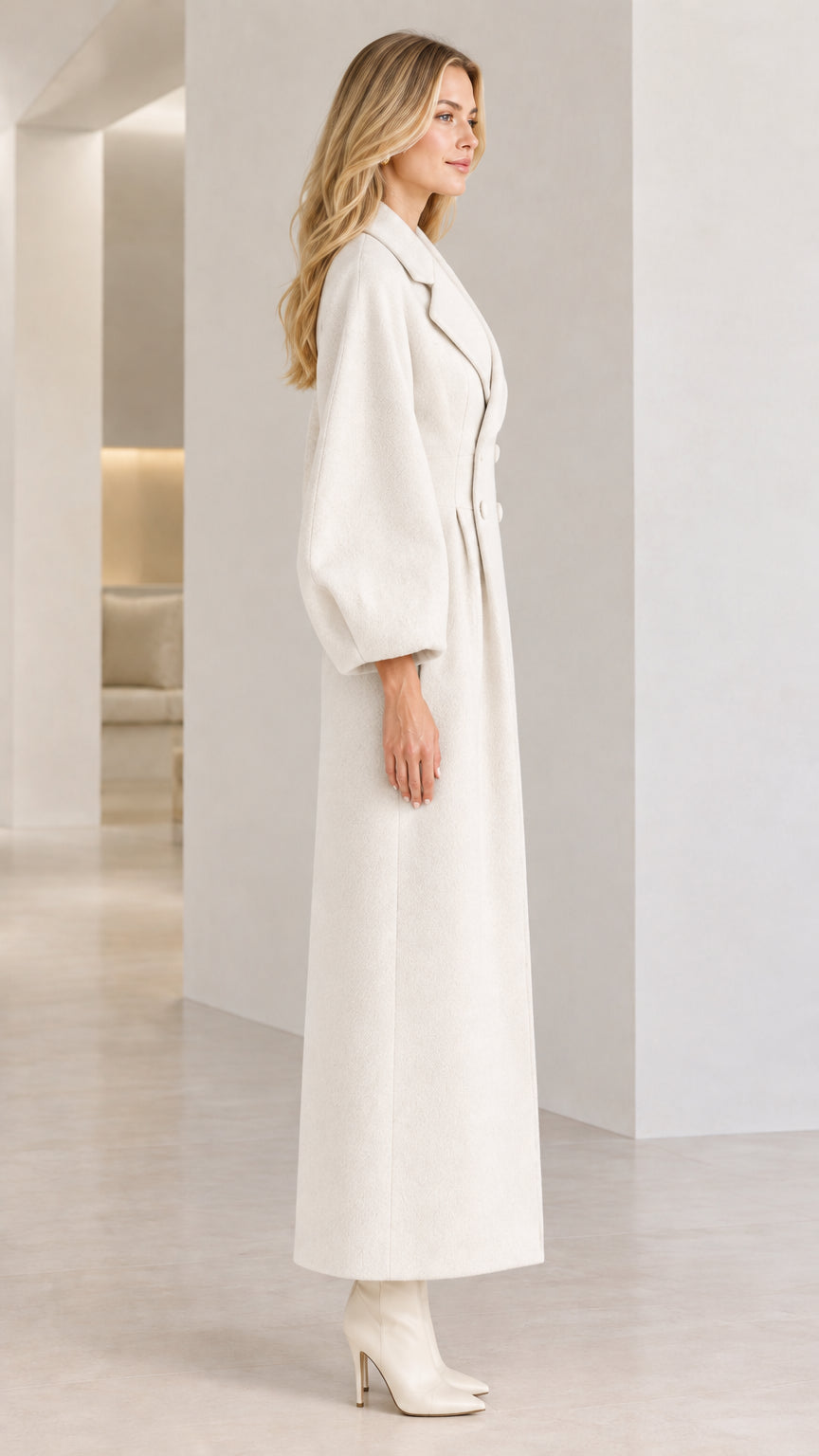 Side profile of woman in Off White long tailored coat with balloon sleeves