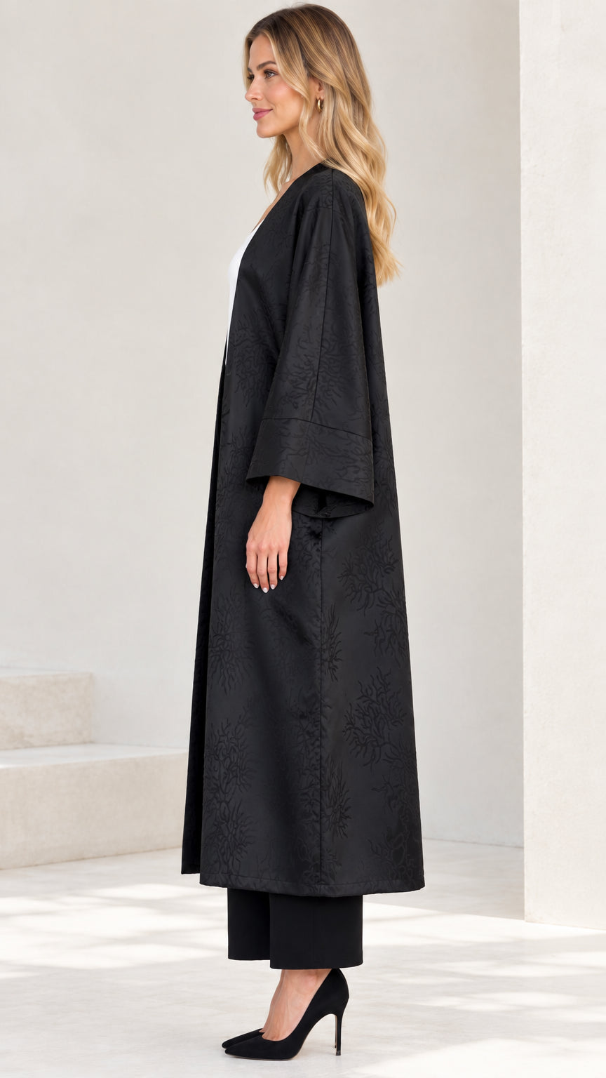 Side profile view of black longline jacquard kimono coat