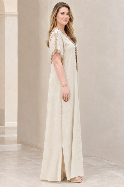 Side angle view of champagne embroidered kaftan dress showing side slit