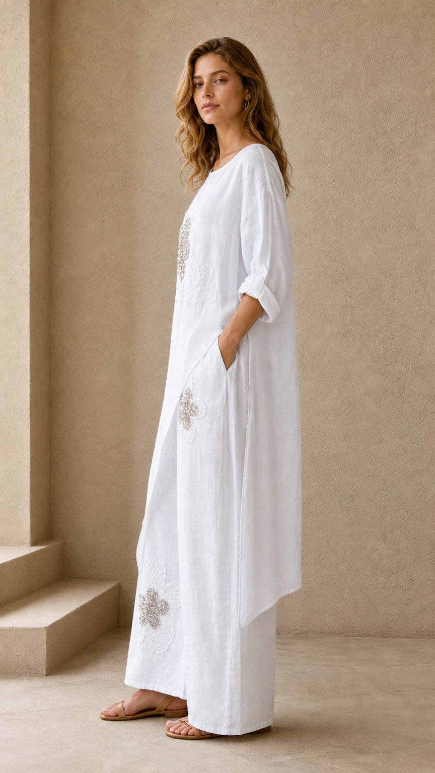 Model wearing white two piece tunic and wide leg pants set - side angled view