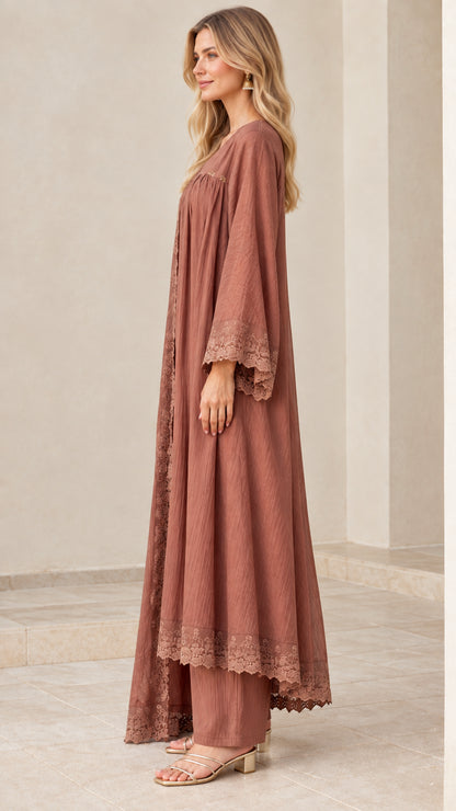Side profile of model in dusty rose crinkle tunic, wide-leg trousers, and duster set