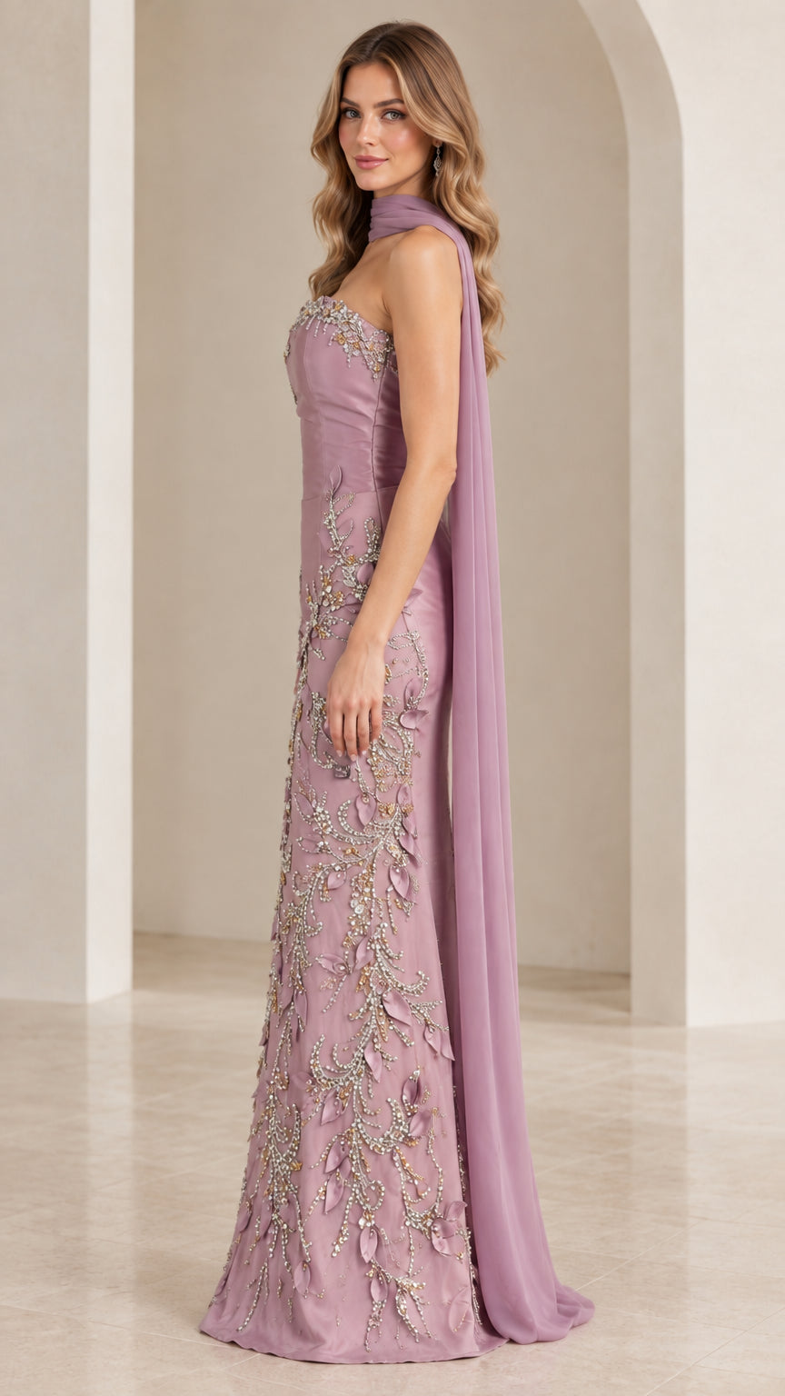 Side profile view of mauve embellished strapless formal dress with flowing back capelet