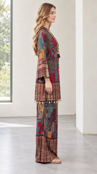 Side profile of model wearing burgundy patterned two-piece tunic set
