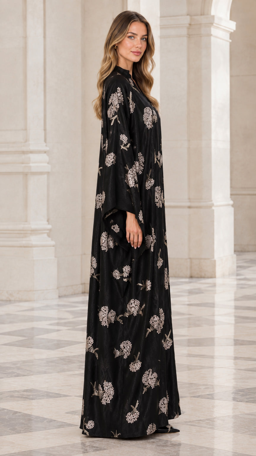 Side angle of woman wearing full length black floral embroidered abaya dress