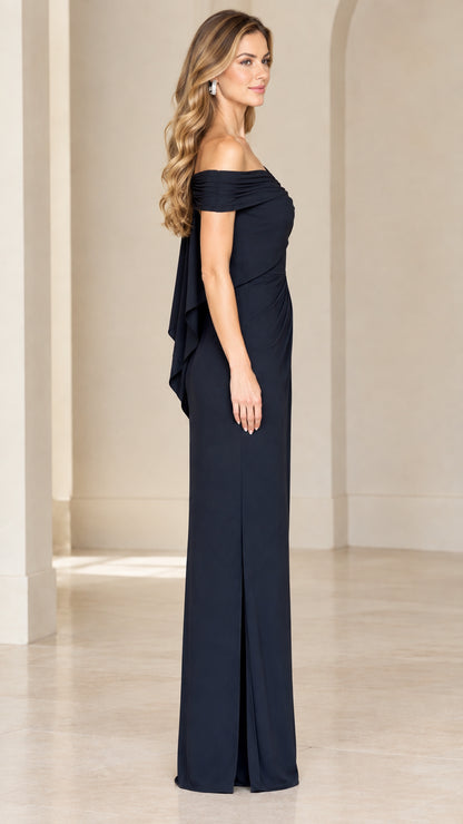 Side view of woman in navy blue floor-length evening dress showing side slit