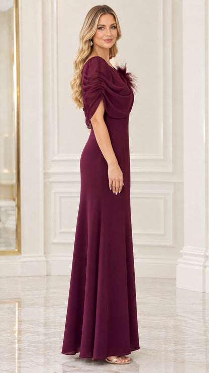 Side profile view of burgundy floor-length evening gown showing capelet sleeve and silhouette