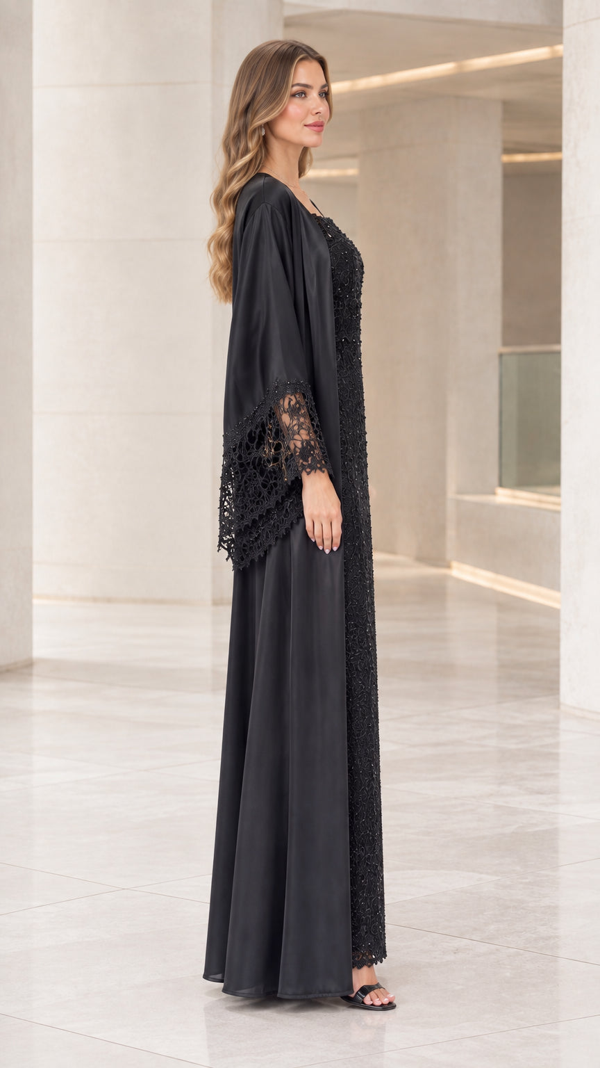 Side profile of model wearing the black lace evening dress and sweeping satin jacket