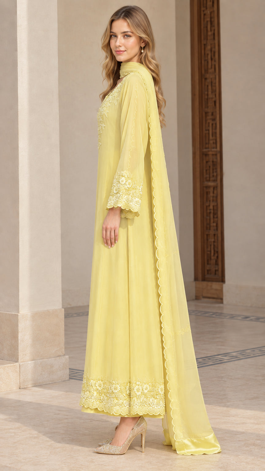 Side profile of woman in elegant yellow embroidered three-piece suit set