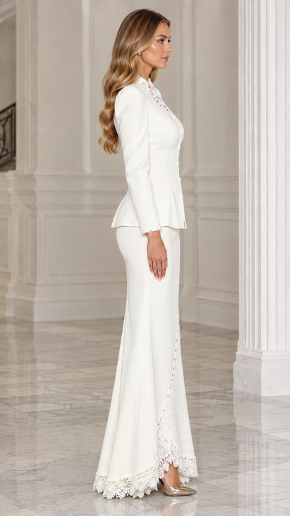 Side profile view of woman wearing white formal skirt suit set with lace hem