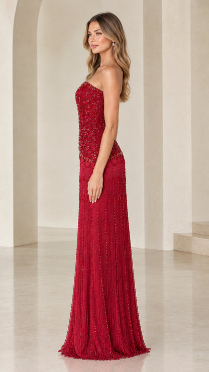 Side profile of woman in strapless ruby red embellished maxi dress
