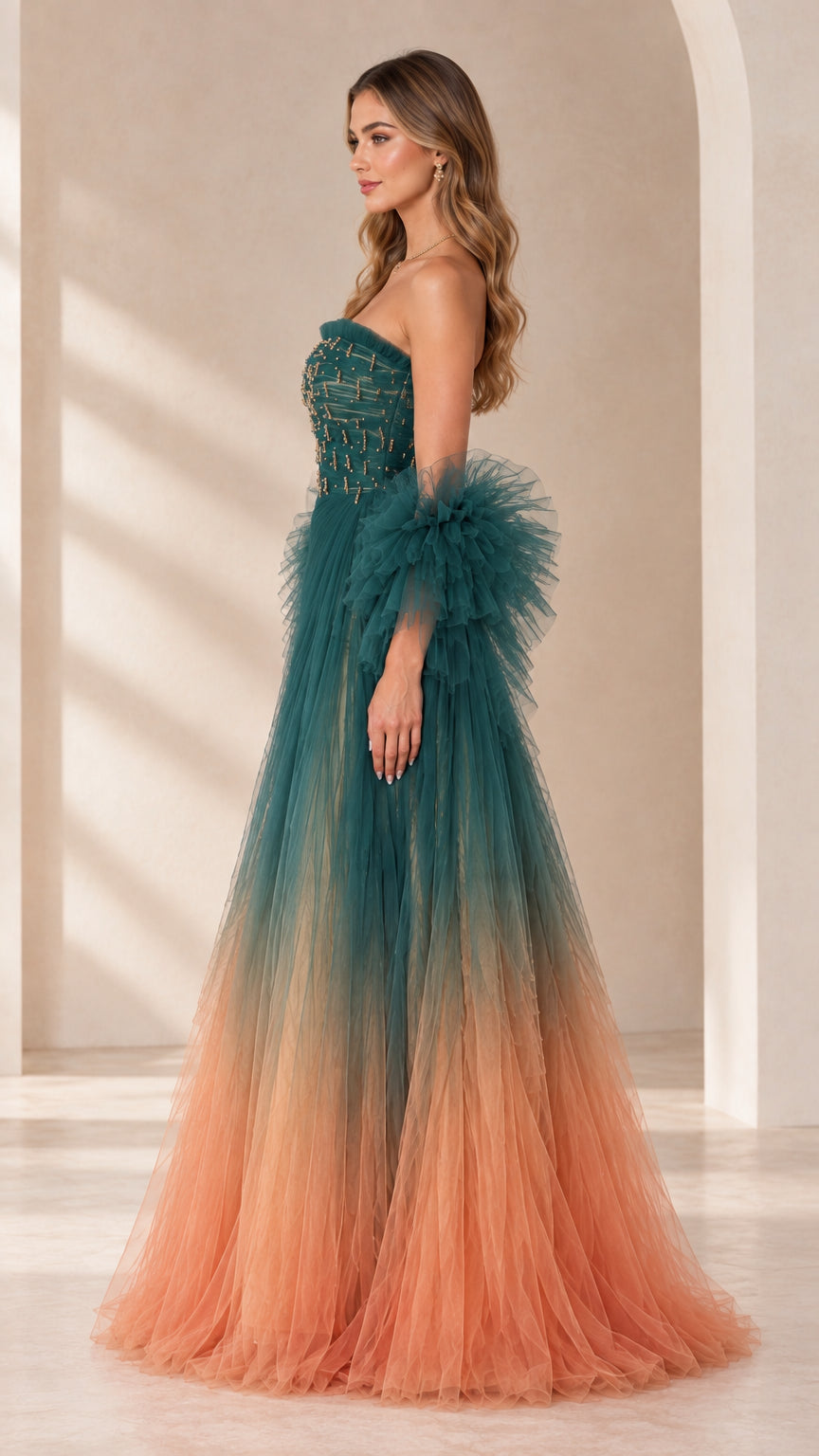 Side profile of teal and peach ombre strapless tulle ball gown