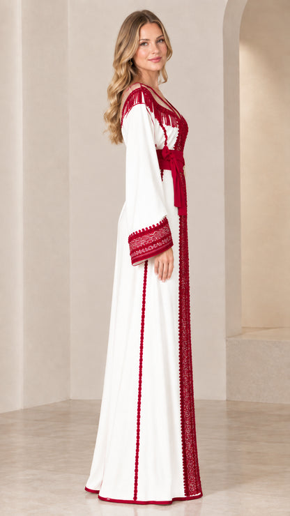 Side profile view of white caftan gown showing flowing maxi skirt and embroidered sleeve
