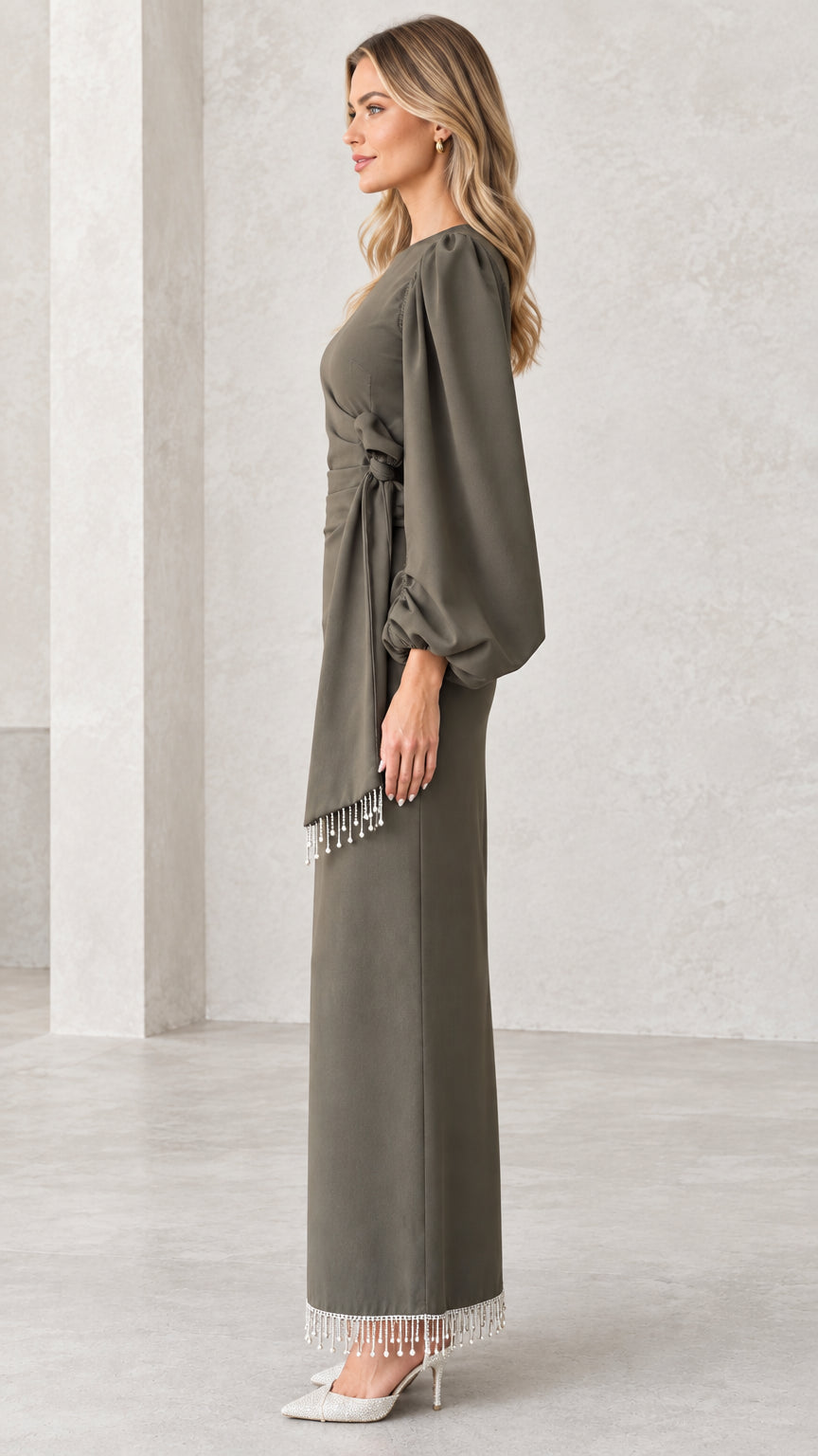Side view of olive green column maxi dress showing side-tie draped waist and beaded hem