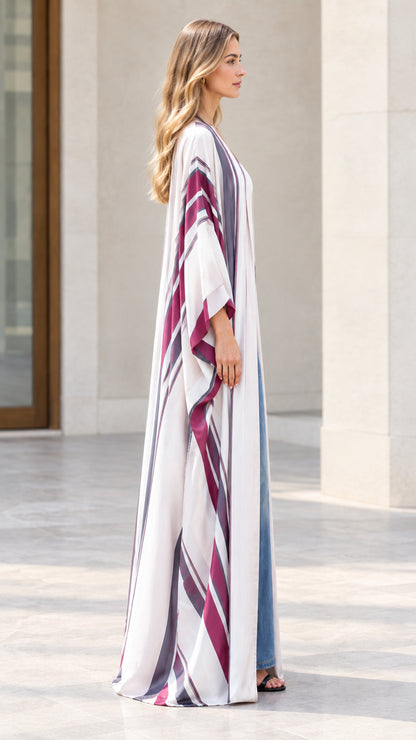 Side profile view of woman wearing flowing off-white striped maxi kimono cardigan