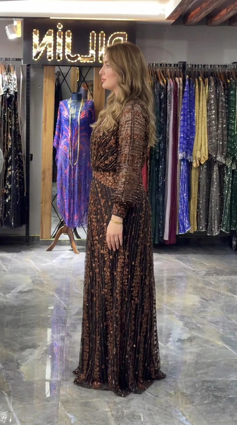 Side view of bronze black formal sequined evening gown showing sleeve and skirt drape