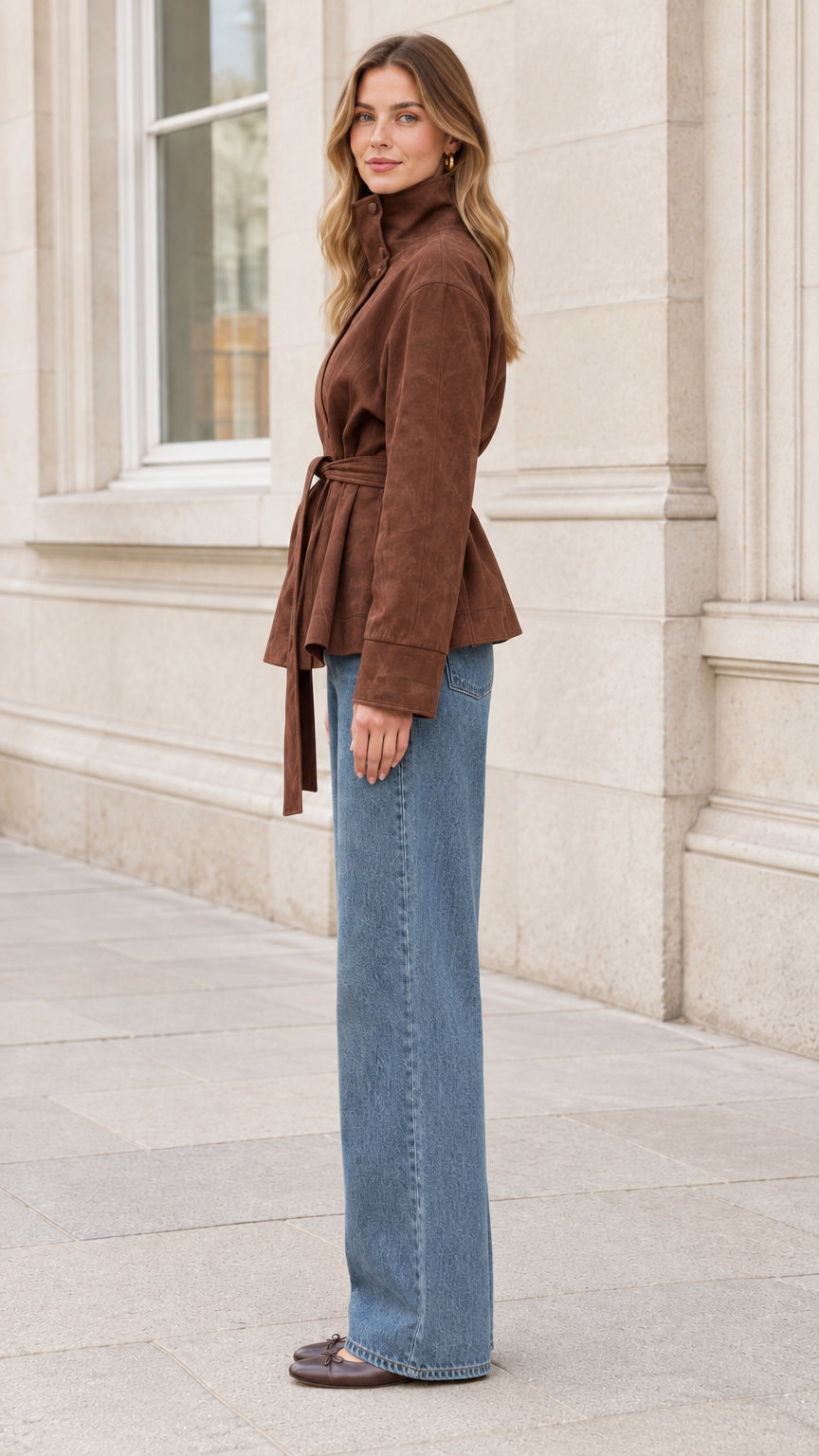 Side profile view of woman wearing brown tie waist faux suede jacket