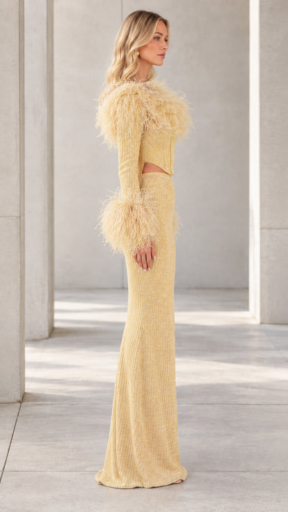 Side profile view of Champagne Gold long sleeve feather evening gown