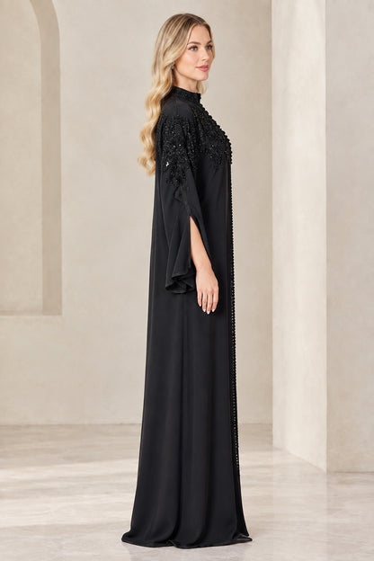 Side profile of woman wearing black maxi abaya with split sleeves