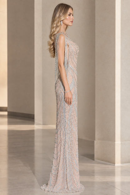 Side profile view of champagne beaded formal dress showcasing shoulder fringe