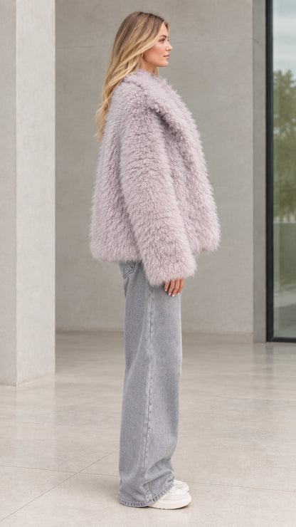 Side profile of model in dusty lilac shaggy plush coat showing relaxed silhouette