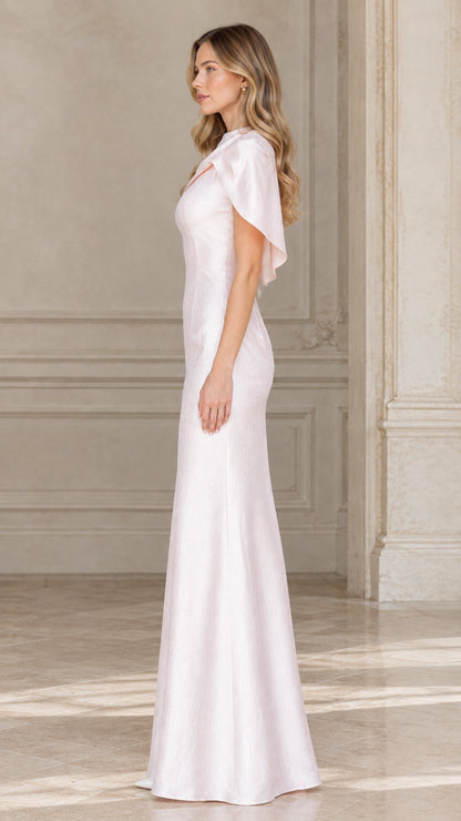 Side profile of woman wearing blush pink capelet formal dress