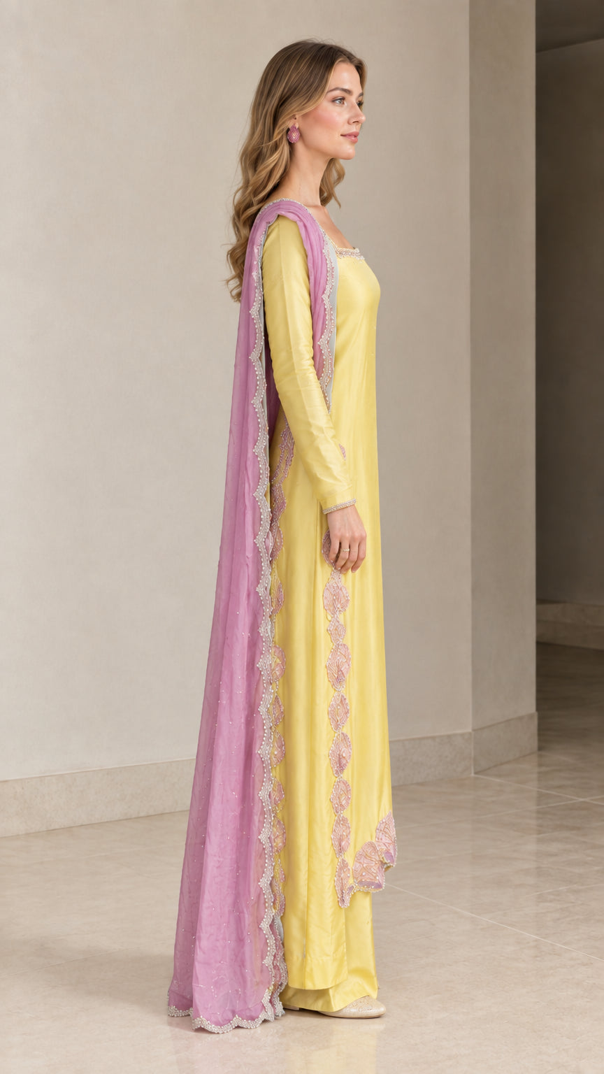 Side angle view of model in Yellow long tunic and wide leg trousers