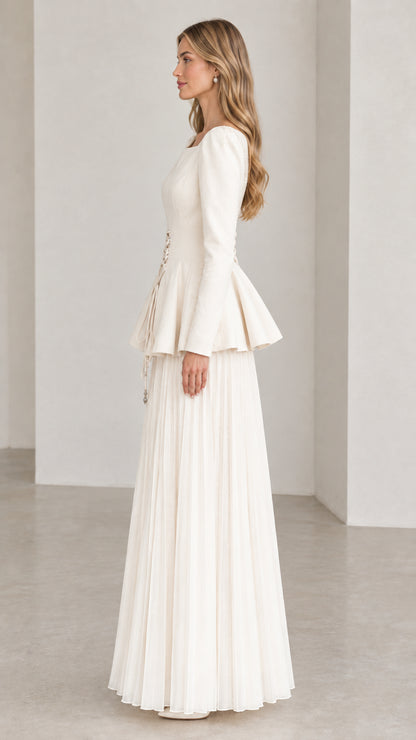 Off-white long sleeve peplum dress side view showing pleated maxi skirt