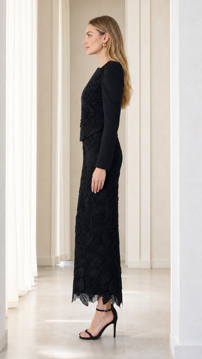 Side profile view of black long sleeve embroidered formal evening gown