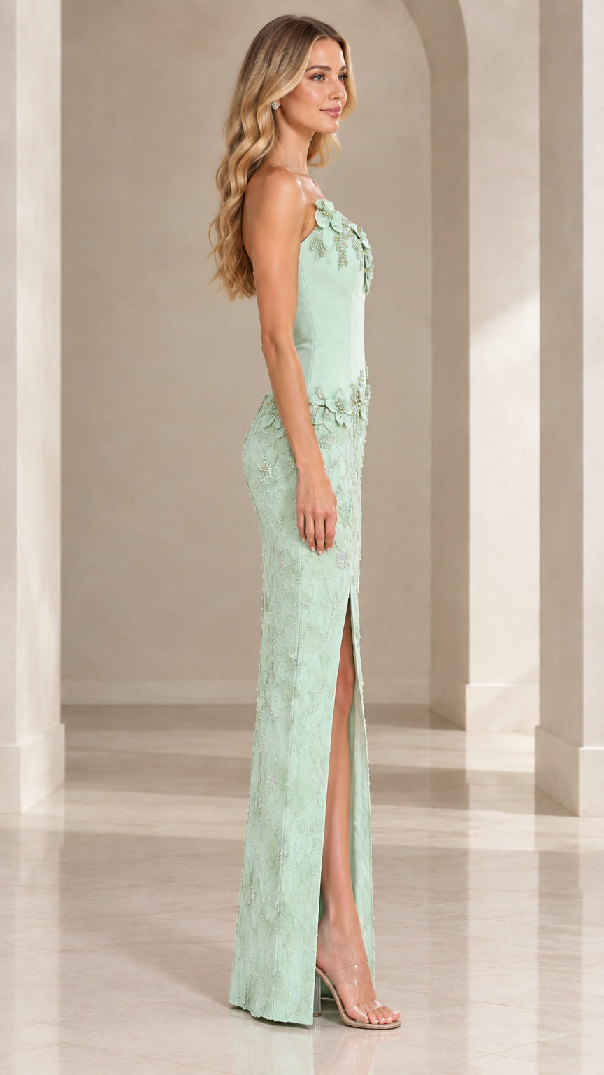 Side profile of mint green asymmetric formal gown showing side slit