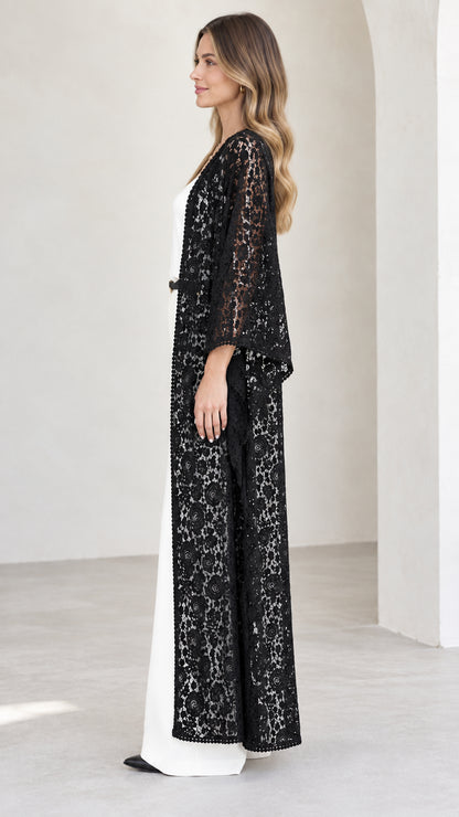 Side profile of model wearing black lace floor-length open-front cardigan