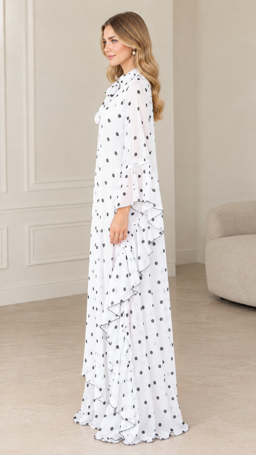 Side profile of flowing white polka dot maxi kaftan dress with ruffle details