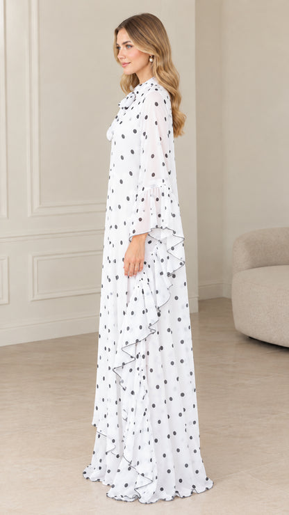 Side profile of flowing white polka dot maxi kaftan dress with ruffle details