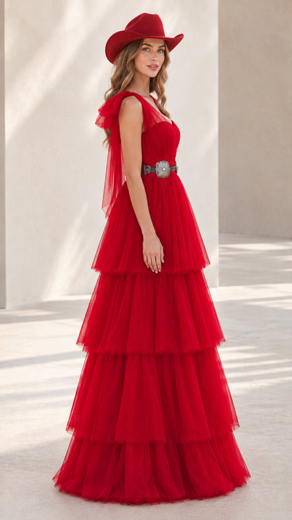 Side angle view of model posing in red ruffled tulle evening dress