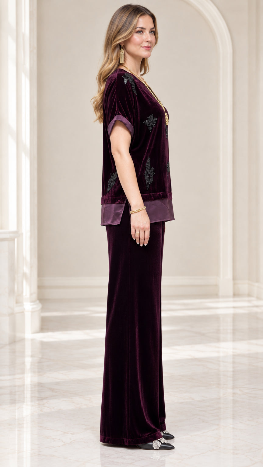 Side profile view of model in Plum velvet two-piece top and matching pants