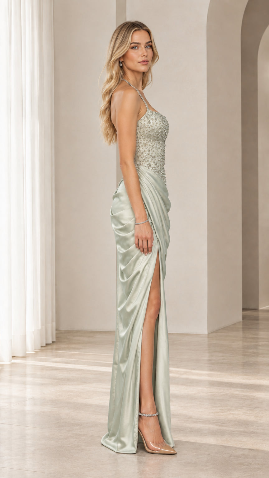 Side profile of model wearing sage green draped satin evening dress