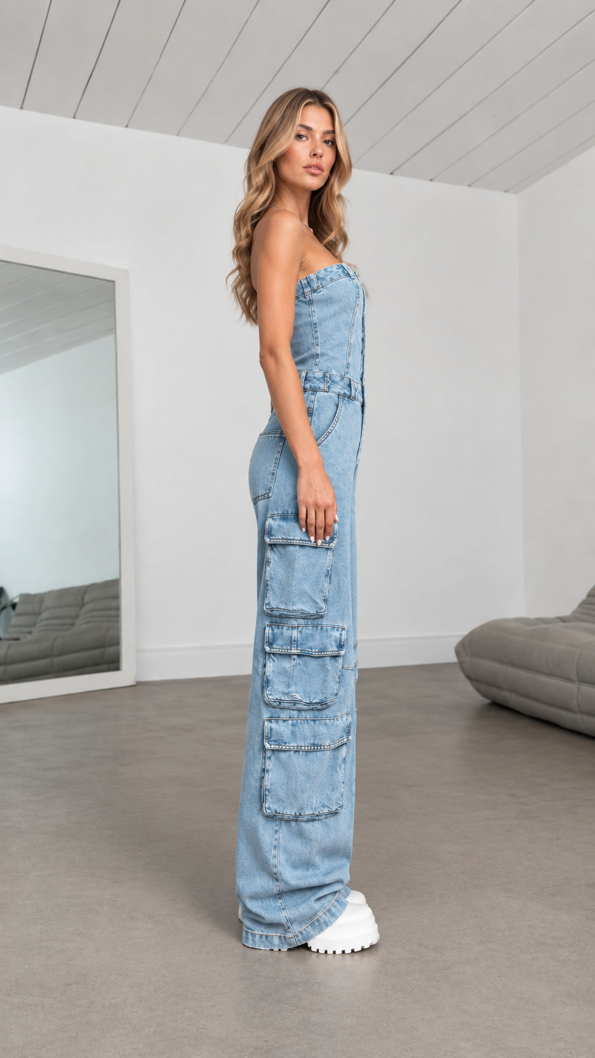 Side profile view of Light Blue strapless denim jumpsuit showing leg cargo flap pockets