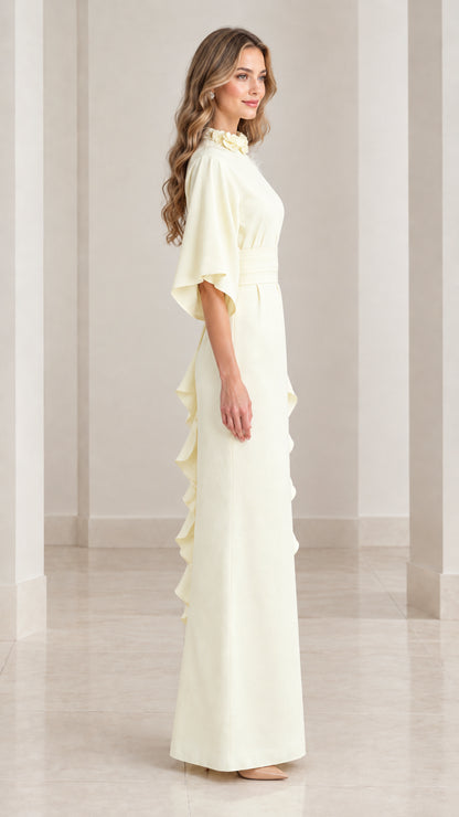 Side profile of elegant butter yellow column evening gown highlighting side ruffle detail