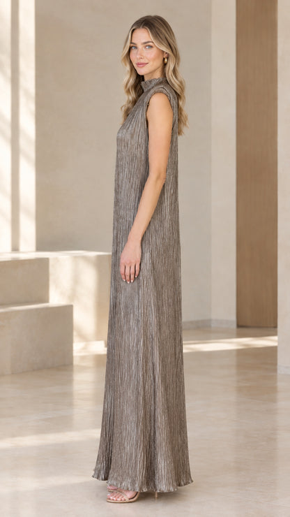 Taupe pleated maxi dress shown from the side with a flowing silhouette