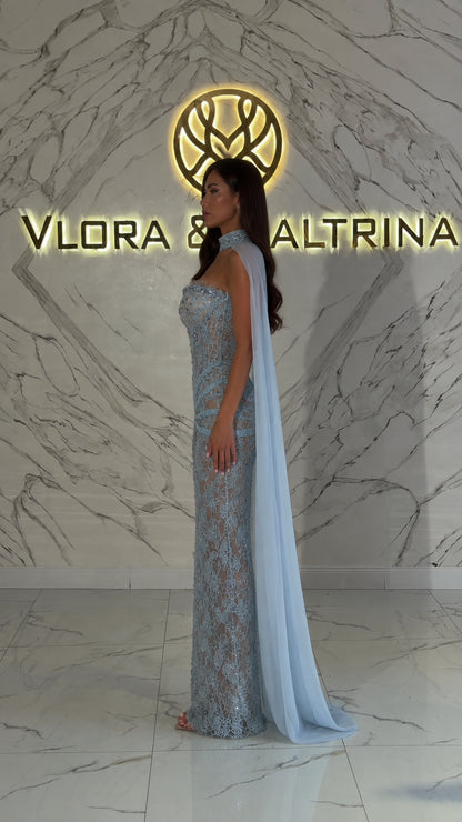 Side profile of light blue embroidered gown with trailing cape