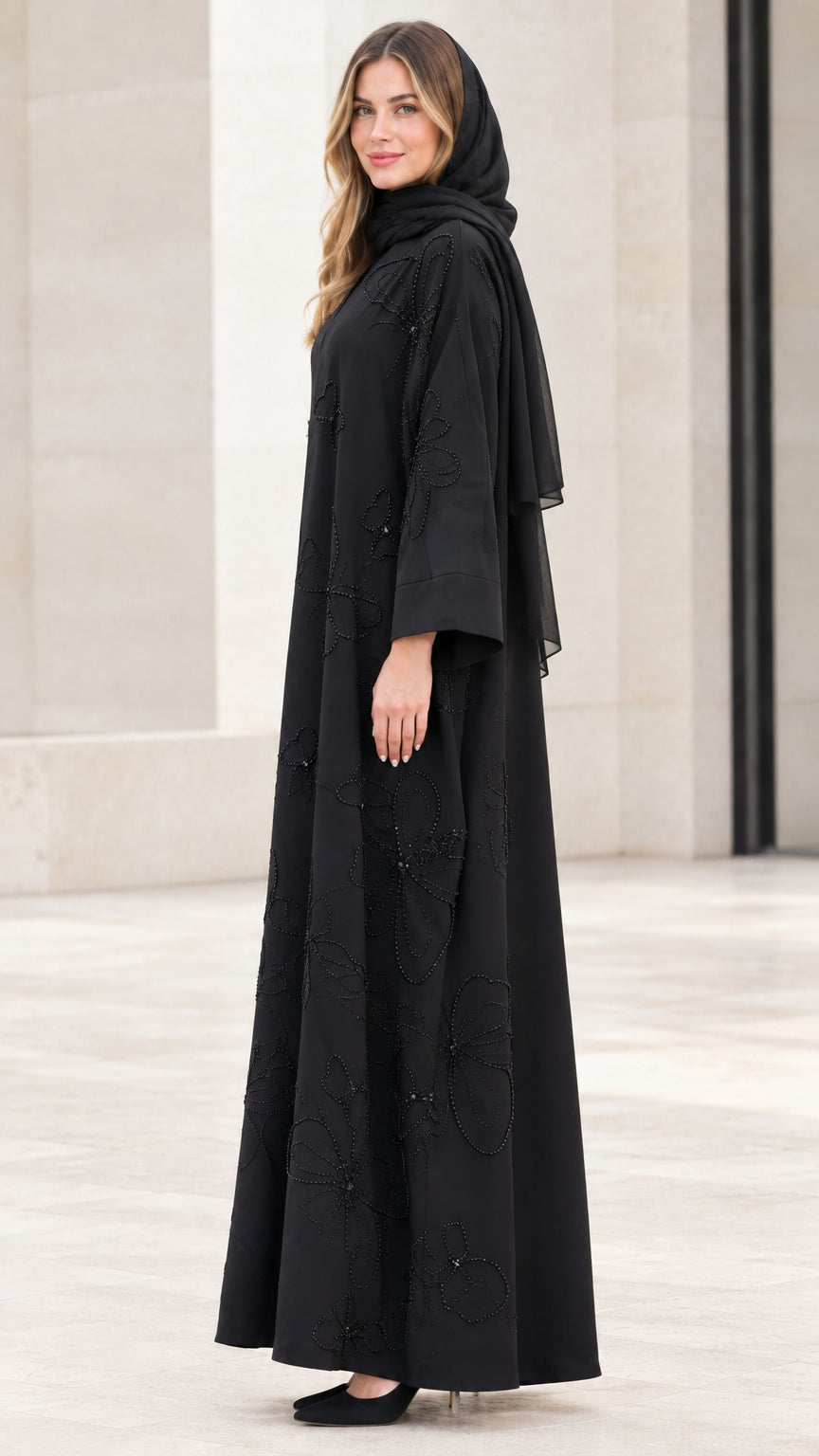 Side profile view of elegant black flowing open-front abaya set
