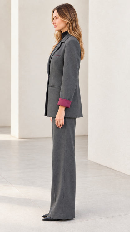 Side profile view of women's tailored charcoal grey suit set with wide trousers