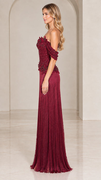 Side profile of burgundy off-the-shoulder beaded bodice maxi gown with fringe skirt