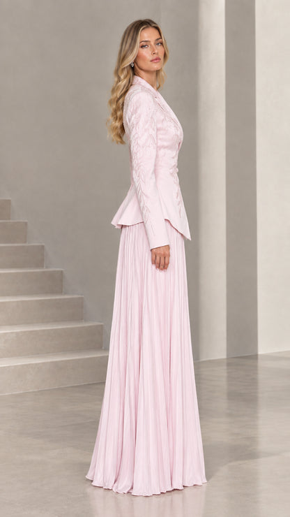 Side profile view of blush pink peplum jacket and accordion pleated formal skirt