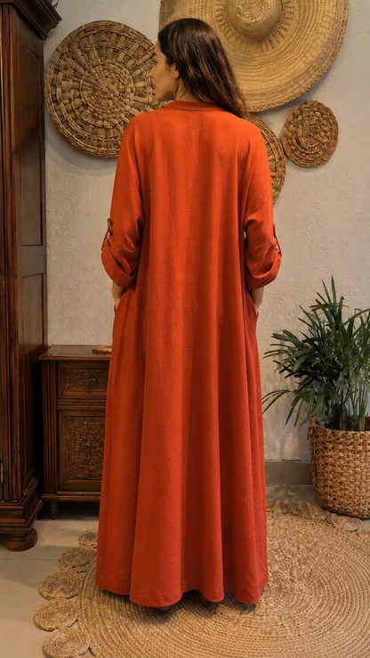 Back view of rust full-length loose kaftan dress with long sleeves