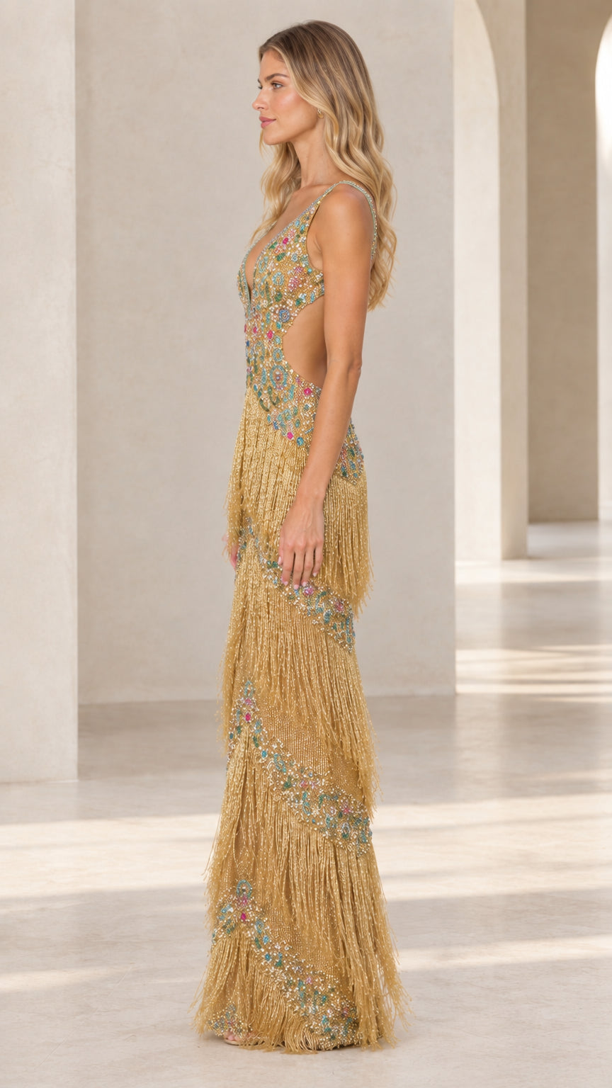 Side profile of gold embellished fringe formal dress showing back and cutout detail